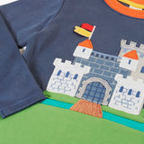 Close up of the details on the castle applique on the Frugi childs organic cotton terrific long sleeve navy top.
