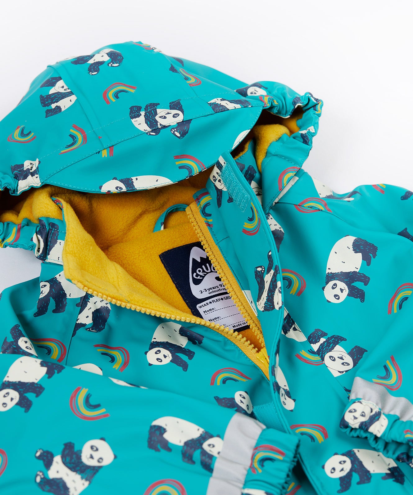 A close up of the Frugi kids panda play puddle buster all in one showing the hood detail and yellow fleece liner. Features a full length zip with velcro fasteners for a secure fit and a name tag stitched on the inside. 