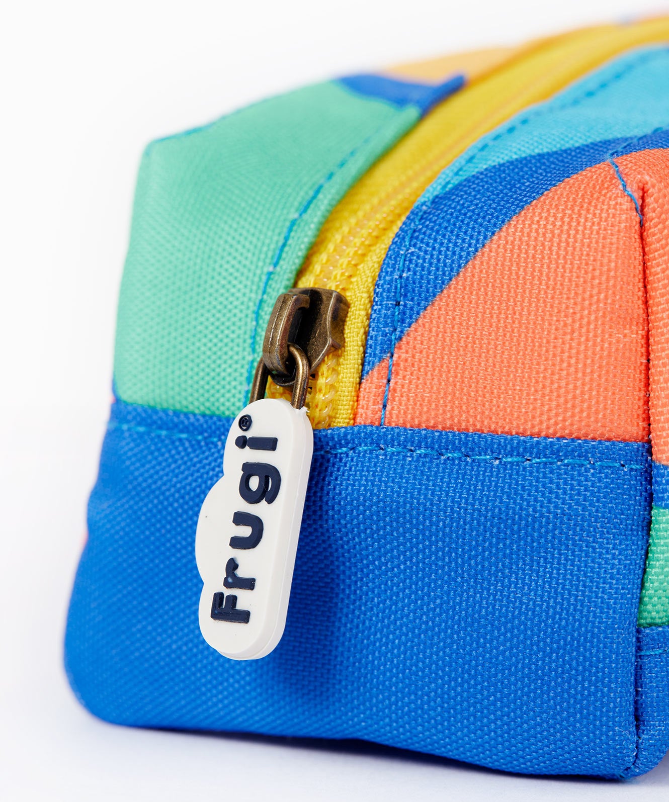 A close up of the Frugi rainbow sun pencil case. Showing the blue trim and zip detail