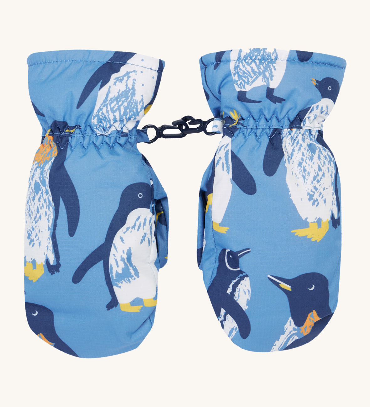 Frugi kids penguin waddle snow mittens. A pair of recycled polyester winter mittens in a light blue with waddling penguins. Features a black clip on each mitten to attach on a ski coat. 