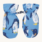 Frugi kids penguin waddle snow mittens. A pair of recycled polyester winter mittens in a light blue with waddling penguins. Features a black clip on each mitten to attach on a ski coat. 