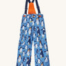 Frugi kids snow and ski salopettes in penguin waddle. A blue recycled polyester waterproof salopettes with waddling penguins. Features removable straps and bib.