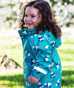 A side view of a toddler wearing the Frugi panda play light blue puddle buster coat showing the elasticated arm cuff detail and print detail