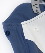 A close up of the popper detail located on the top side on the Frugi navy panda puddle buster waterproof trousers for a snug fit.