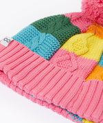 A close up of the Frugi kids cable knit rainbow check bobble hat. Showing the thick cable knit and pink turned up cuff