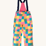 Frugi kids snow and ski salopettes in rainbow check. A recycled polyester waterproof salopettes with a bright check design. Features removable straps and bib.