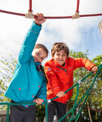 Two children wearing the Frugi kids 3 in 1 rambler coats, one in fire orange , one in boat blue.