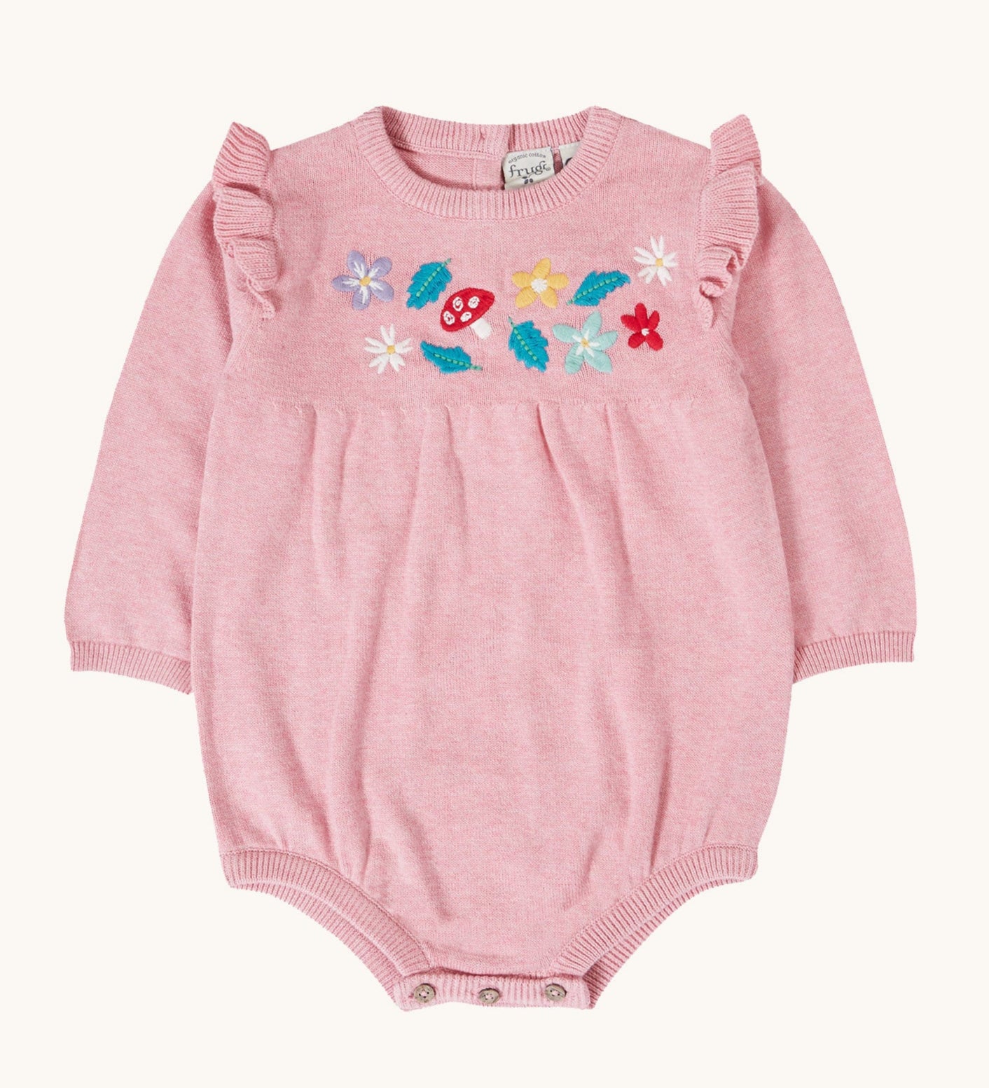 Frugi kids remi knitted romper in pink marl /flowers available at Babipur. A GOTS organic cotton soft knitted romper suit with long sleeves and frilled shoulders. Features button fasteners at at crotch and woodland inspired embroidery on the front.