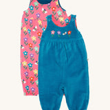 Frugi kids reversible helen dungarees in boat blue/fun flowers available at Babipur. A 100% GOTS organic cotton dungaree with a blue corduroy and flower applique on the front and a pink reversible side with playful flower prints. Features popper fasteners on the shoulder straps and cuffed  ankles.