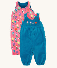 Frugi kids reversible helen dungarees in boat blue/fun flowers available at Babipur. A 100% GOTS organic cotton dungaree with a blue corduroy and flower applique on the front and a pink reversible side with playful flower prints. Features popper fasteners on the shoulder straps and cuffed  ankles.