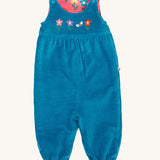 Frugi kids reversible helen dungarees in boat blue. A 100% GOTS organic cotton dungaree in blue corduroy with playful flower appliques on the front. Features popper fasteners on the shoulder straps and cuffed  ankles.