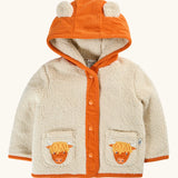 A frugi baby hooded cardigan jacket in cream sherpa with an orange corduroy hood, trim, and front placket. The hood has two cow ears, and the front pockets feature embroidered Scottish Highland cow faces.