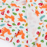 A close up of the Frugi shay body 2 pack in squirrel play/soft white showing the cute playful squirrel print and popper fastener detail on organic cotton fabric.