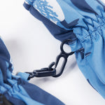 A close up of the Frugi kids penguin waddle snow mittens showing the black clip detail on each mitten that can be attached on a ski coat.