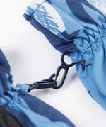 A close up of the Frugi kids penguin waddle snow mittens showing the black clip detail on each mitten that can be attached on a ski coat.