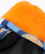 A close up of the Frugi kids penguin waddle snow mittens showing the black grippy palm and orange fleece inner for warmth 