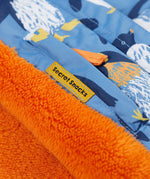 A close up of the Frugi kids snow and ski coat in penguin waddle showing the hidden pocket on the inside and orange fleece detail