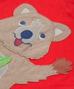 Close up of the Frugi kids strawberry quokka tshirt. Showing the brown quokka appliqué on red organic cotton fabric