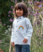 Frugi kids shacket, shirt with blue and white stripes and rainbow design worn by a child