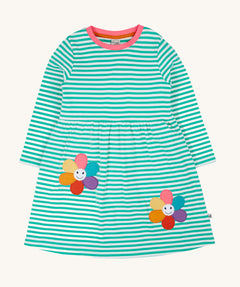 Frugi kids tammy dress in dragon stripes/flowers available at Babipur. A 100% GOTS organic cotton dress with long sleeve in light blue and white stripes with pink trim. Features 2 playful flower appliques on the skirt.