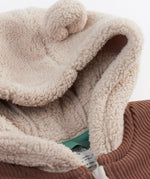 A close up of the Frugi kids ted cord snuggle suit showing the hood detail with cute bear like ears 