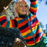 A child wearing the Frugi Autumn stripe ted fleece. A long sleeve striped thick fleece with light blue trim and turn up collar.