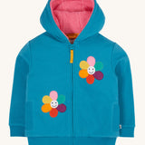 Frugi kids ted fleece hoodie in boat blue/flowers available at Babipur. A 100% Oeko-Tex cotton bright blue jersey hoodie with a pink ted fleece inner. Features a full length zip, 2 playful flower appliques and side pockets.