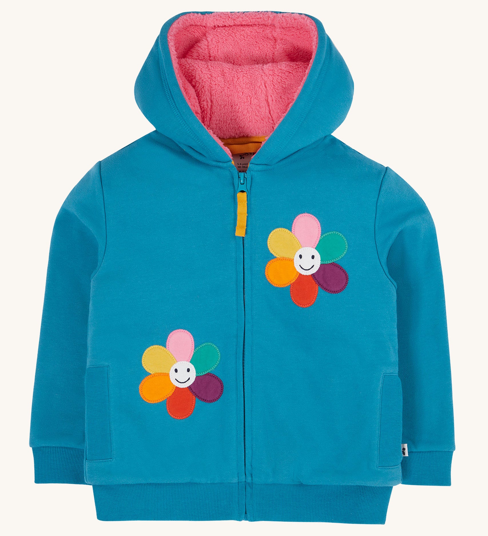 Frugi kids ted fleece hoodie in boat blue/flowers available at Babipur. A 100% Oeko-Tex cotton bright blue jersey hoodie with a pink ted fleece inner. Features a full length zip, 2 playful flower appliques and side pockets.