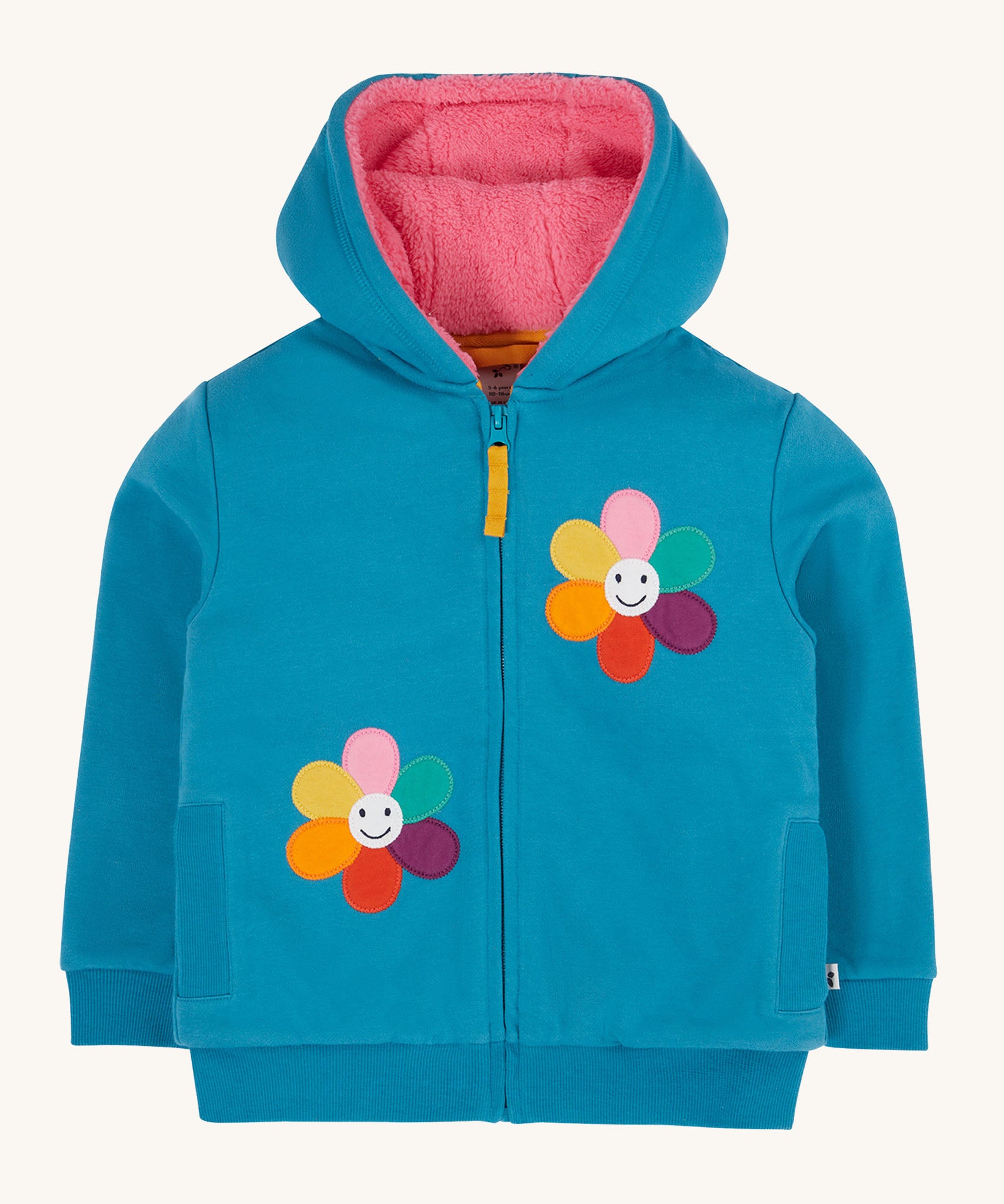 Frugi kids ted fleece hoodie in boat blue/flowers available at Babipur. A 100% Oeko-Tex cotton bright blue jersey hoodie with a pink ted fleece inner. Features a full length zip, 2 playful flower appliques and side pockets.