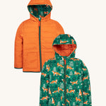 Frugi kids toasty trail reversible jacket in squirrel / fox colourway. A post consumer recycled polyester jacket with a playful fox in woodland design and a orange colour side. Features a hood, 2 side pocket and a green full length zip.