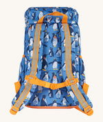 The back of the Frugi kids trail blazing backpack in penguin waddle showing the shoulder strap detail with orange trim. Features a handy loop for easy carrying and chest buckle for a secure fit