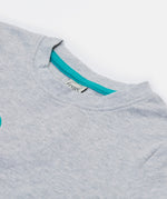 A close up of the Frugi kids grey marl lemur character t- shirt. showing the light blue trim on the inside of the neck grey marl organic cotton fabric