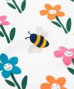 Frugi Sundown organic cotton fun flowers pyjamas. A multi-coloured flower print on a crisp white cotton background.