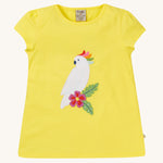 Frugi Children's Organic Cotton Cassia Applique T-Shirt - Cockatoo. A gorgeous sunny yellow, organic cotton Frugi T-Shirt for children features a gorgeous cockatoo applique with a colourful rainbow crest
