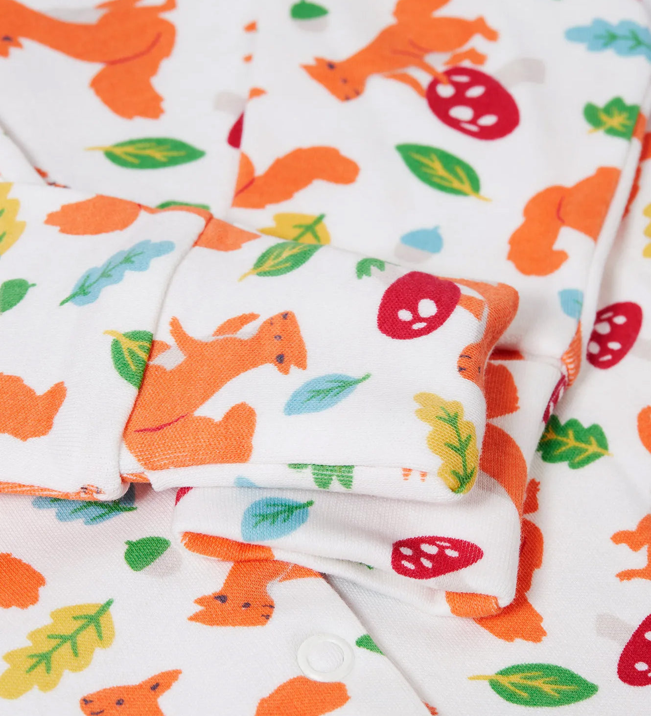 A closeup of the Frugi Organic Cotton Kimono Zip Babygrow squirrel print