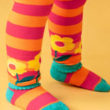 Close up of the bscalopped edges on the cuffs of the Frugi orange and pink striped knitted leggings. The bottoms have yellow flowers around them.