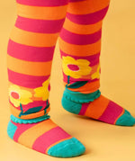Close up of the bscalopped edges on the cuffs of the Frugi orange and pink striped knitted leggings. The bottoms have yellow flowers around them.