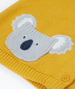 A close up of the organic knitted cotton grey koala bear pocket of the Frugi kids yellow koala cardigan 