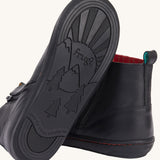 The black coloured rubber soles on the Frugi lake easy on child's leather shoe boots in black. 