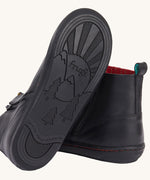 The black coloured rubber soles on the Frugi lake easy on child's leather shoe boots in black. 