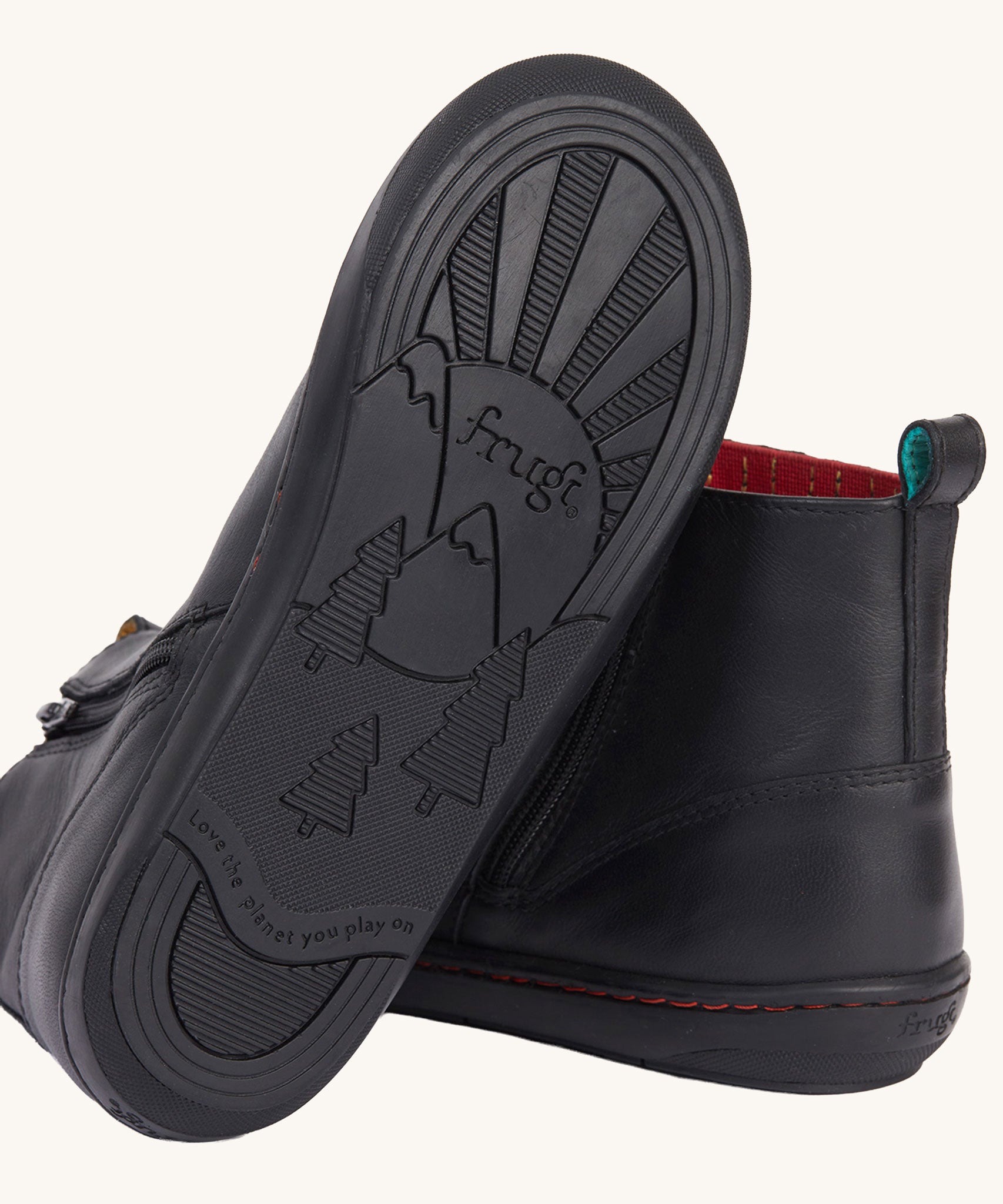 The black coloured rubber soles on the Frugi lake easy on child's leather shoe boots in black. 