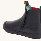 A close up of the zip on the side of the Frugi lake easy on child's leather shoe boots in black. 