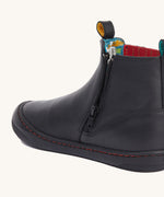 A close up of the zip on the side of the Frugi lake easy on child's leather shoe boots in black. 