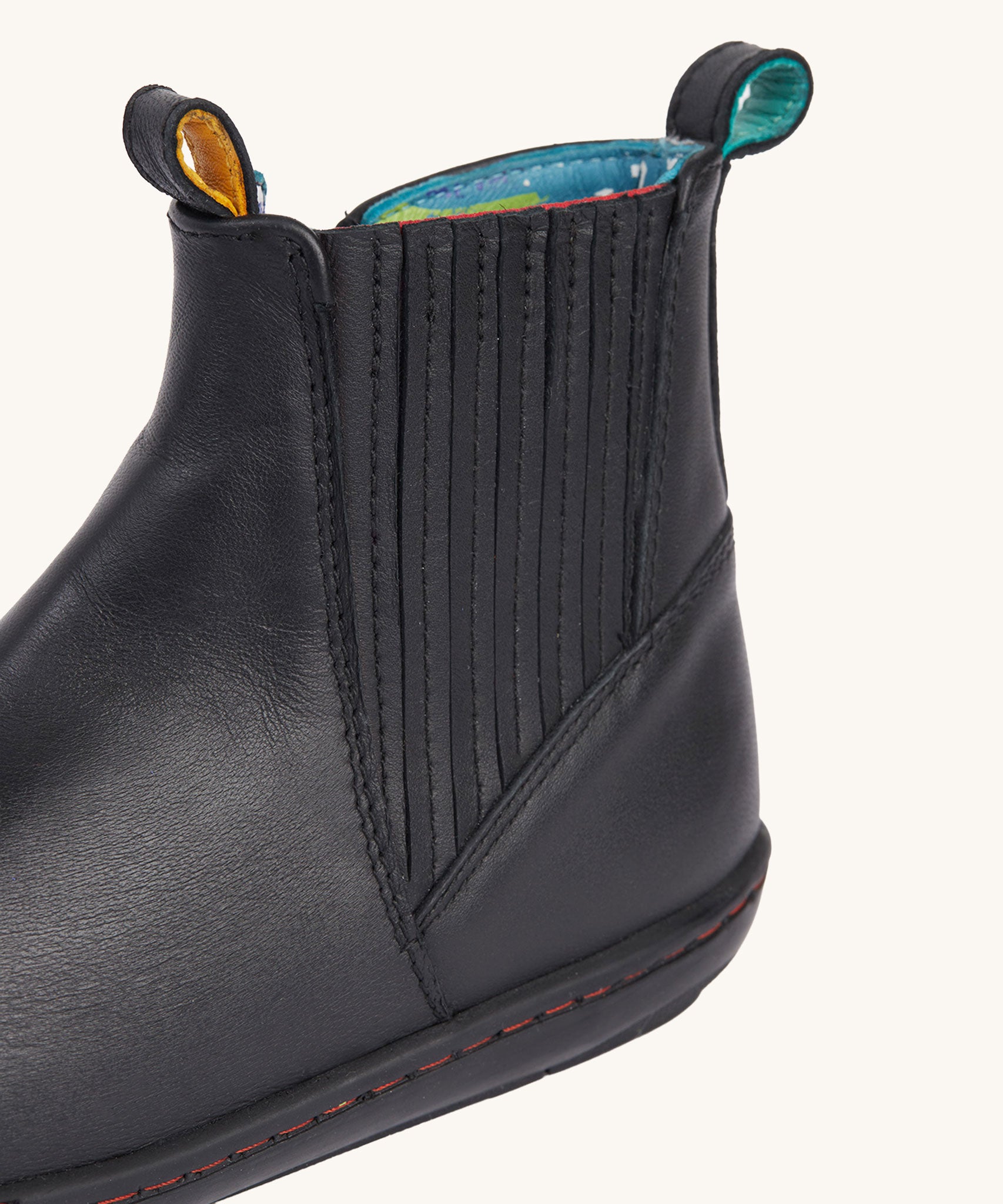 A close up of the stripe details on the side of the Frugi lake easy on child's leather shoe boots in black. 