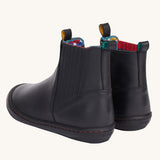 A view of the back of the Frugi lake easy on child's leather shoe boots in black. The boots have a matching black pull tab on them.
