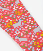 A close up of the Frugi kids donkey drove libby leggings. Showing the grey donkey and multicoloured flower design on light pink organic cotton fabric.