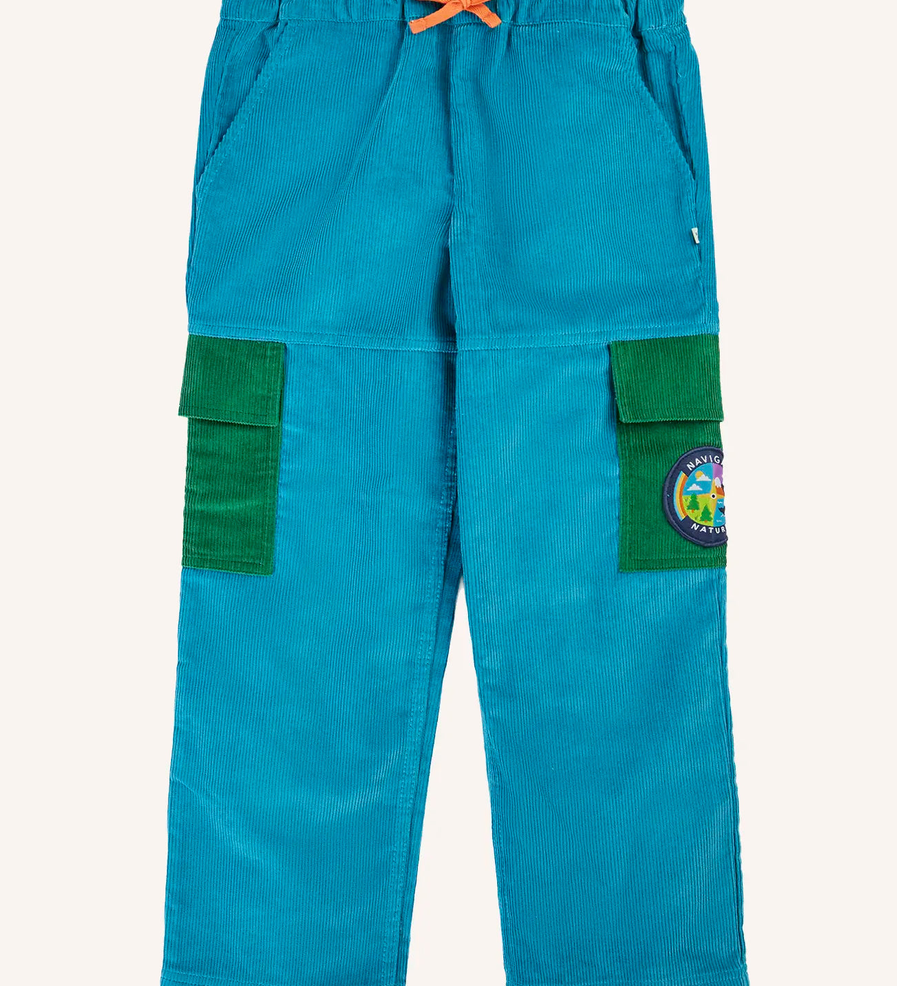 Frugi Lennox adventure trousers in boat blue organic cotton corduroy with green side pockets on the leg, one decorated with a nature themed badge.