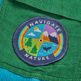 Frugi GOTS 100% organic cotton adventure corduroy trousers in blue showing a playful outdoor compass patch on green side pocket