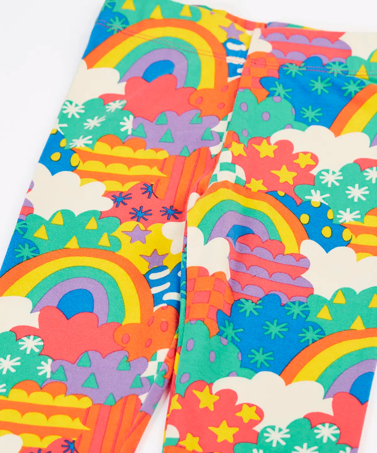 Close up of the Frugi Leona organic cotton leggings with a colourful fun frenzy print.