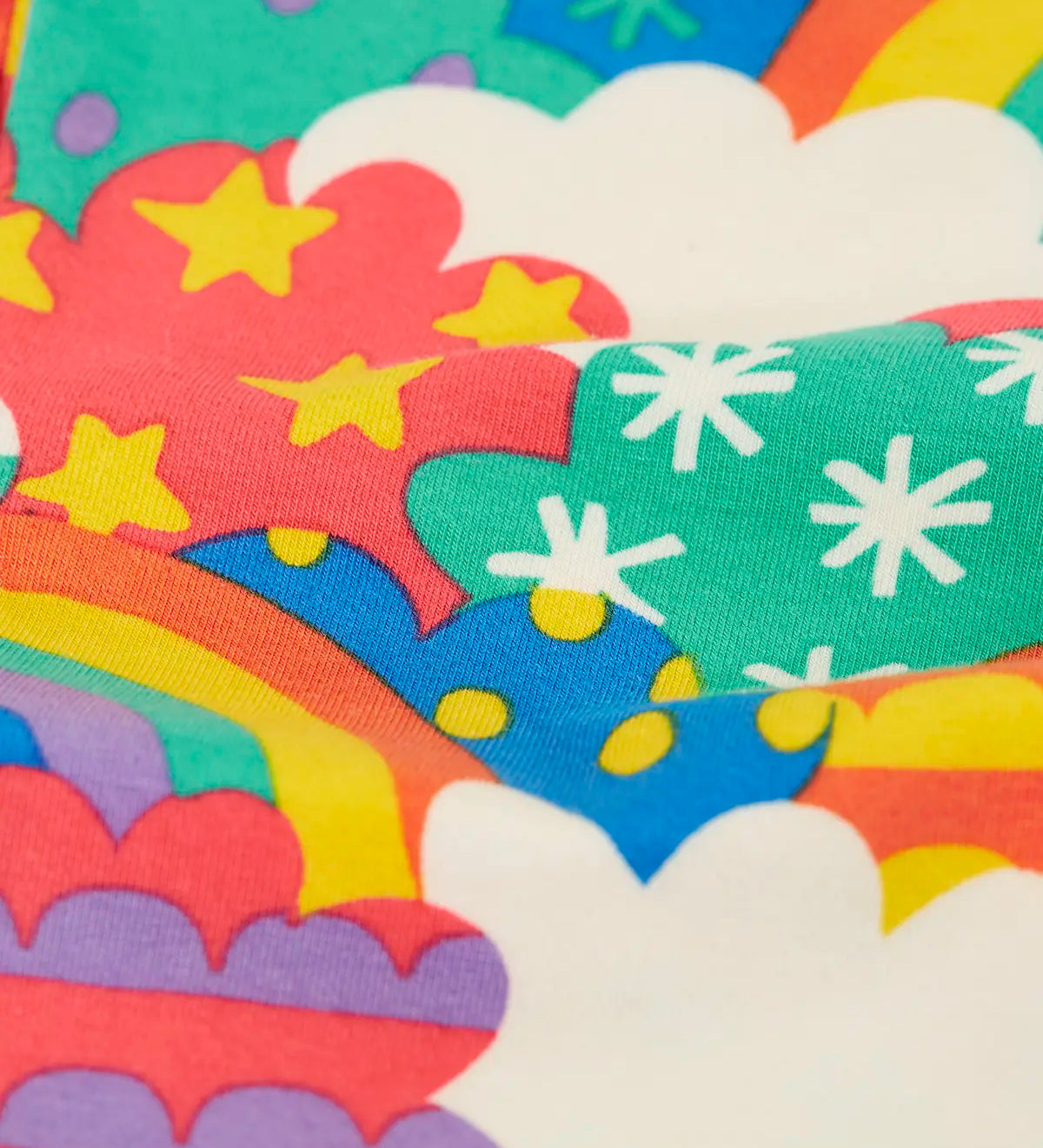 Close up of the soft organic cotton of the Frugi Leona leggings with a colourful fun frenzy print.